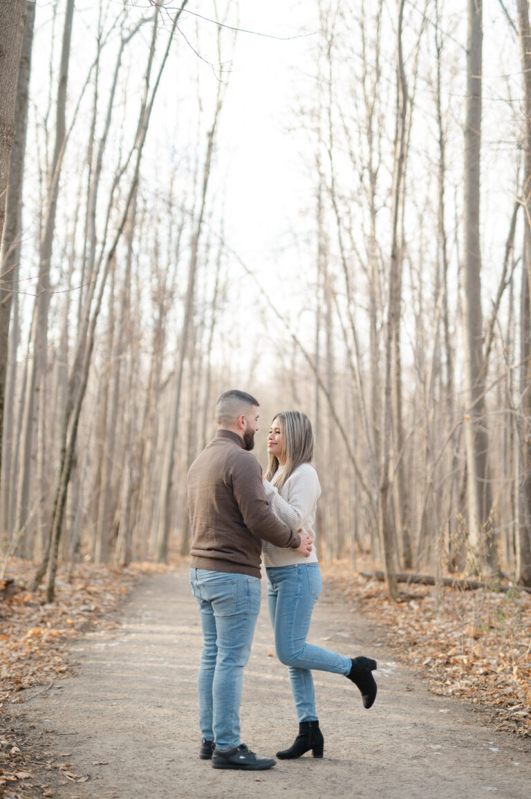 The engaged couple on a wooded path in Laval